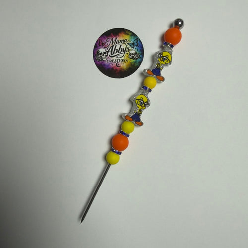 Colorful beaded hair stick with 'Mama Abby's Creations' logo on a white background